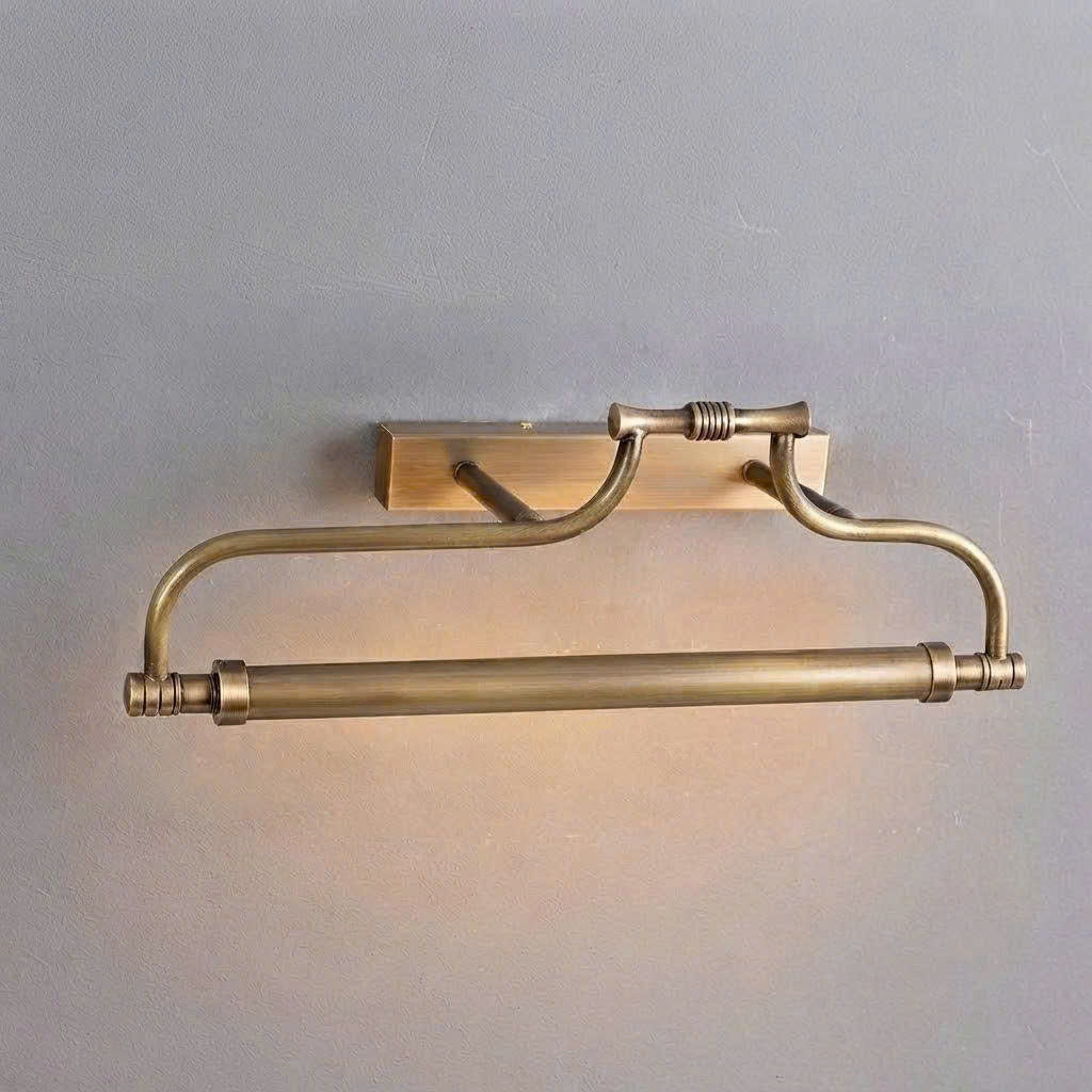 A wall-mounted brass towel bar with a matching wall hook, shown against a plain light gray wall.