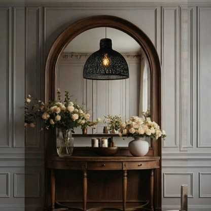 A stylish black bamboo dome pendant light hanging in a bright entryway, creating a warm and welcoming first impression.