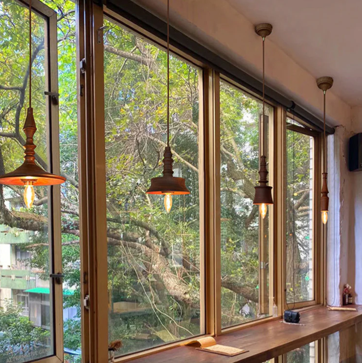 Ceiling pendant in Mid-Century Modern style, made from turned wood, adding organic texture to interior design spaces.