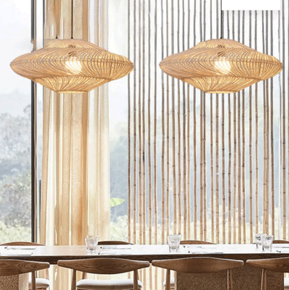 Coastal boho rattan hanging light fixture with a unique curved silhouette and warm internal illumination.