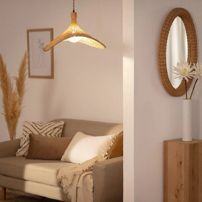 Aesthetic natural fiber hanging lamp in a sun hat shape creating a relaxing, warm atmosphere for a neutral-toned space.
