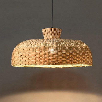 Ethically sourced drop light with rattan dome weave, creating a pure atmosphere in the bedroom.