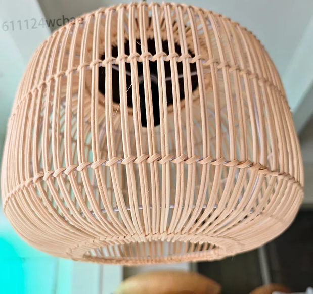 Eco-friendly rattan cylinder lamps grouped together with minimalist dark cords for a cozy, warm lighting.