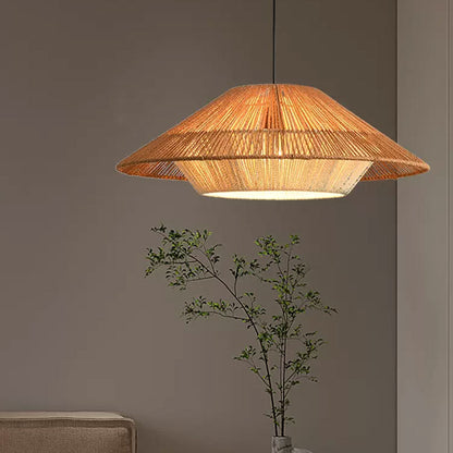 Layered straw conical ceiling light comparison with a glowing amber light bulb illuminated through fine organic cord wrappings.