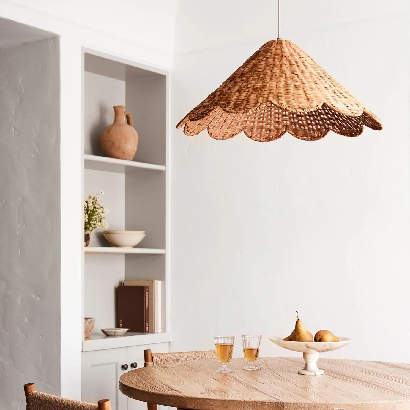 Sophisticated hand-woven rattan light enhancing the warmth and comfort of a modern dining room.