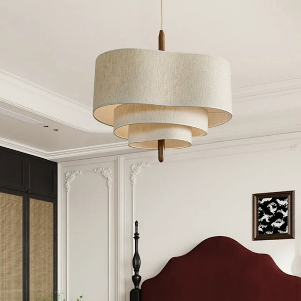 Handcrafted tiered fabric hanging light featuring a wooden center