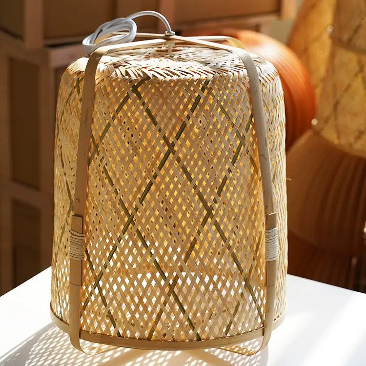Sustainable handmade bamboo cylindrical hanging lamp with organic texture for eco-friendly home decor.