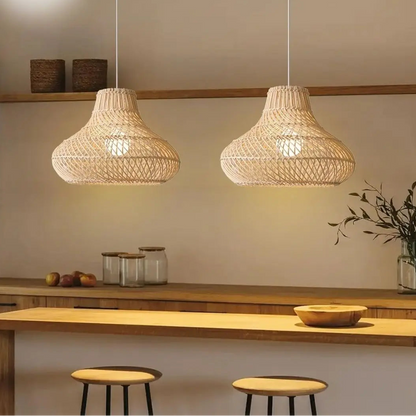 Handwoven bamboo pendant light suspended elegantly above a modern kitchen island setup.