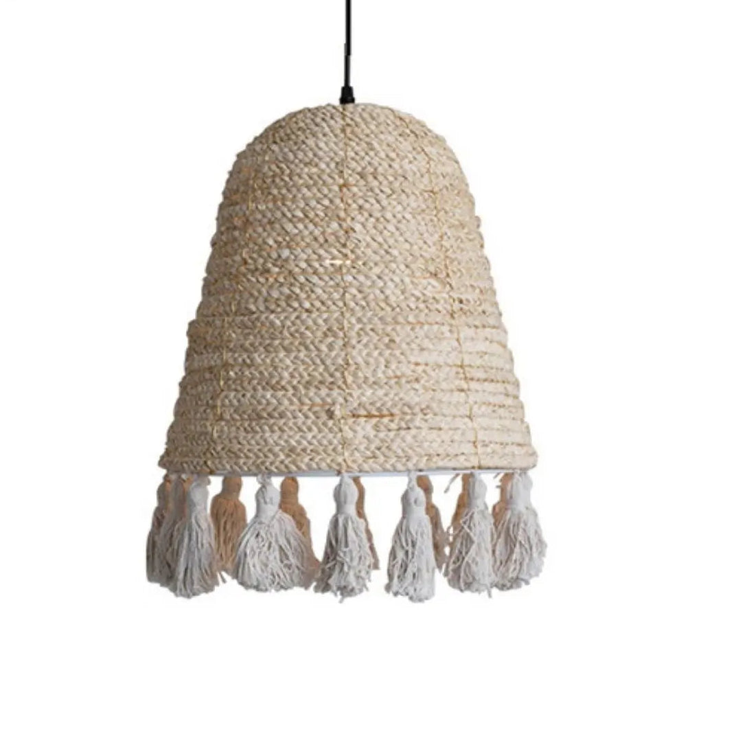 A close-up view of a handwoven natural hyacinth bell pendant light with tassel