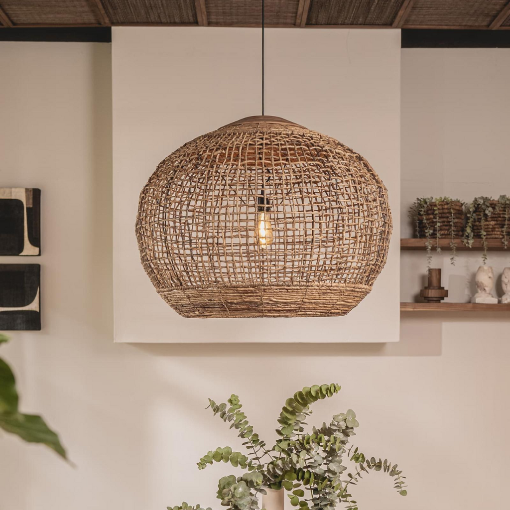 Handwoven natural rattan globe pendant light with warm interior glow