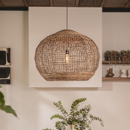 Handwoven natural rattan globe pendant light with warm interior glow