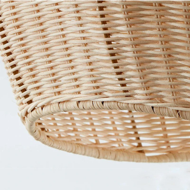 Handwoven natural rattan oval pendant light with detailed organic weave texture