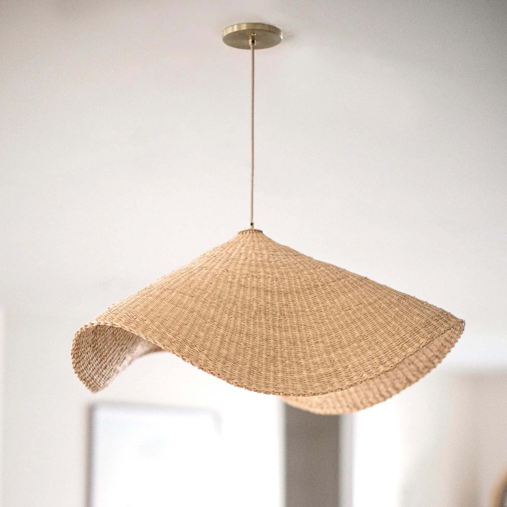 Handwoven natural rattan pendant light with organic texture and sustainable material