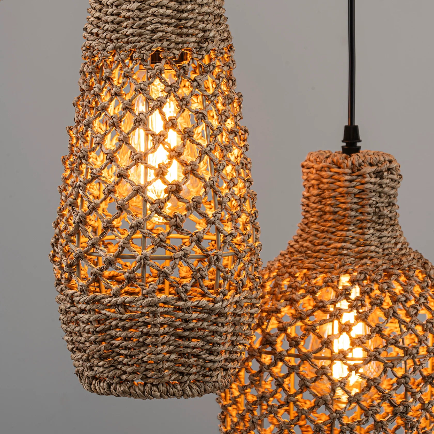 Handwoven natural seagrass dome pendant light with intricate weave texture and organic aesthetic.