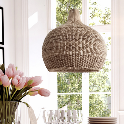 Artisan handwoven rattan pendant light hanging over a modern dining table