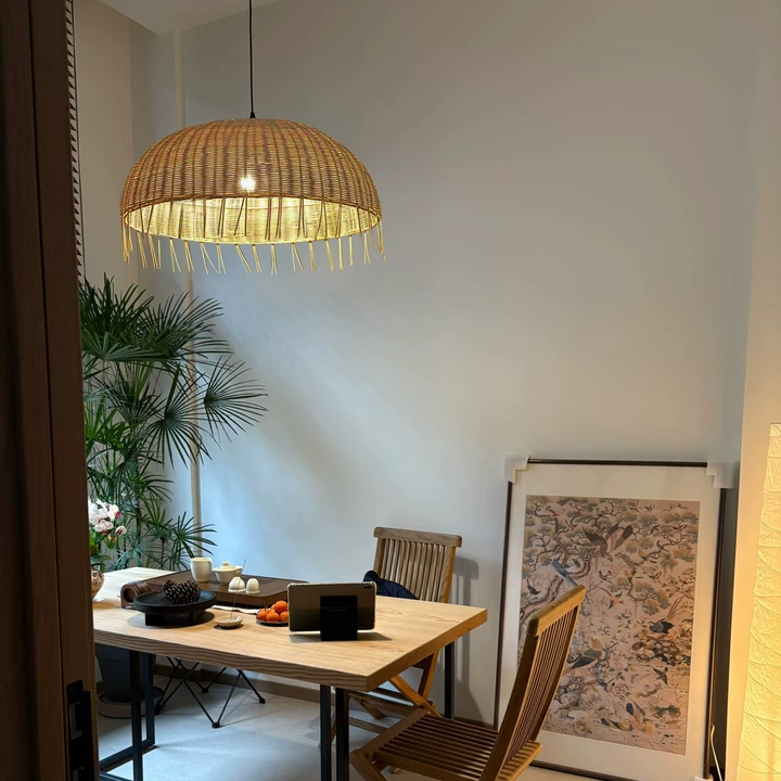 Cozy home style hanging lamp in natural rattan fringe, creating an inviting reading nook
