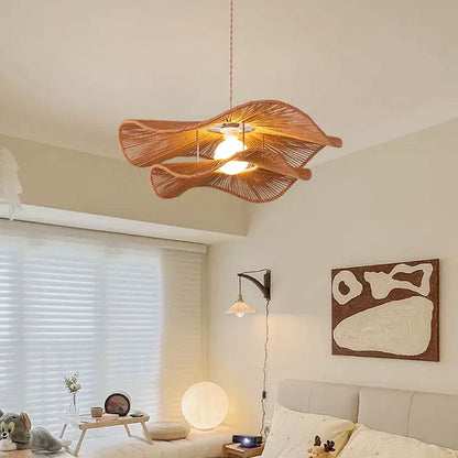 Premium wicker chandelier with a wide flowing profile adding dynamic natural textures to a boutique hotel reception or contemporary cafe.