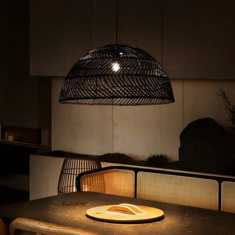 Minimalist Japandi Black bamboo pendant lamp cluster arranged in a tiered layout above a set dinner table.