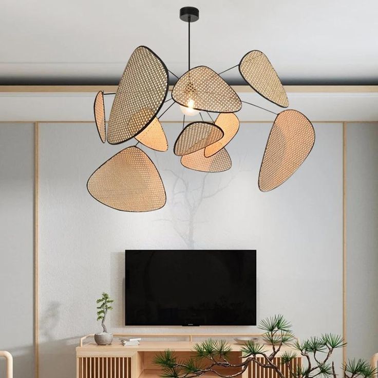 Minimalist Japandi hanging chandelier with natural rattan webbing panels creating a dramatic, organic silhouette