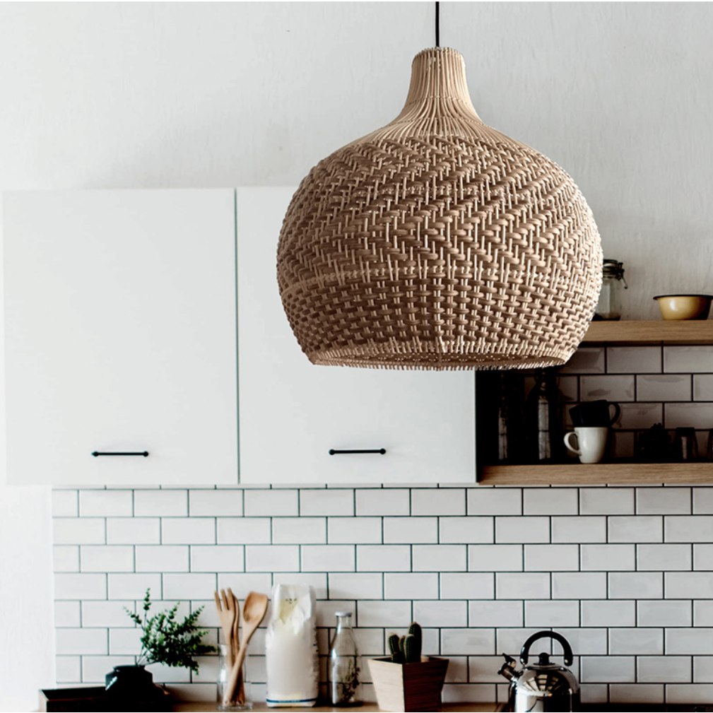 Natural rattan hanging lamp installed over a modern kitchen island