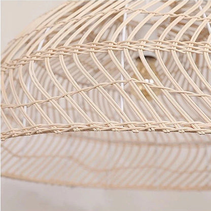 Large rattan basket pendant light in a deep bowl shape casting an elegant lattice pattern glow into the room.