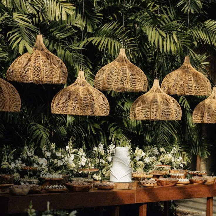 Grand tiered woven rattan light fixture enhancing the tropical, serene atmosphere of a luxury resort villa