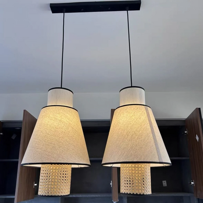 Mid-century inspired rattan and linen lamp, combining retro texture with a clean and modern design form.