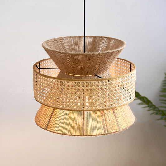 Minimalist layered bamboo pendant lamp showing a unique multi-tier structure suspended from clean black cords against rustic wooden beams.