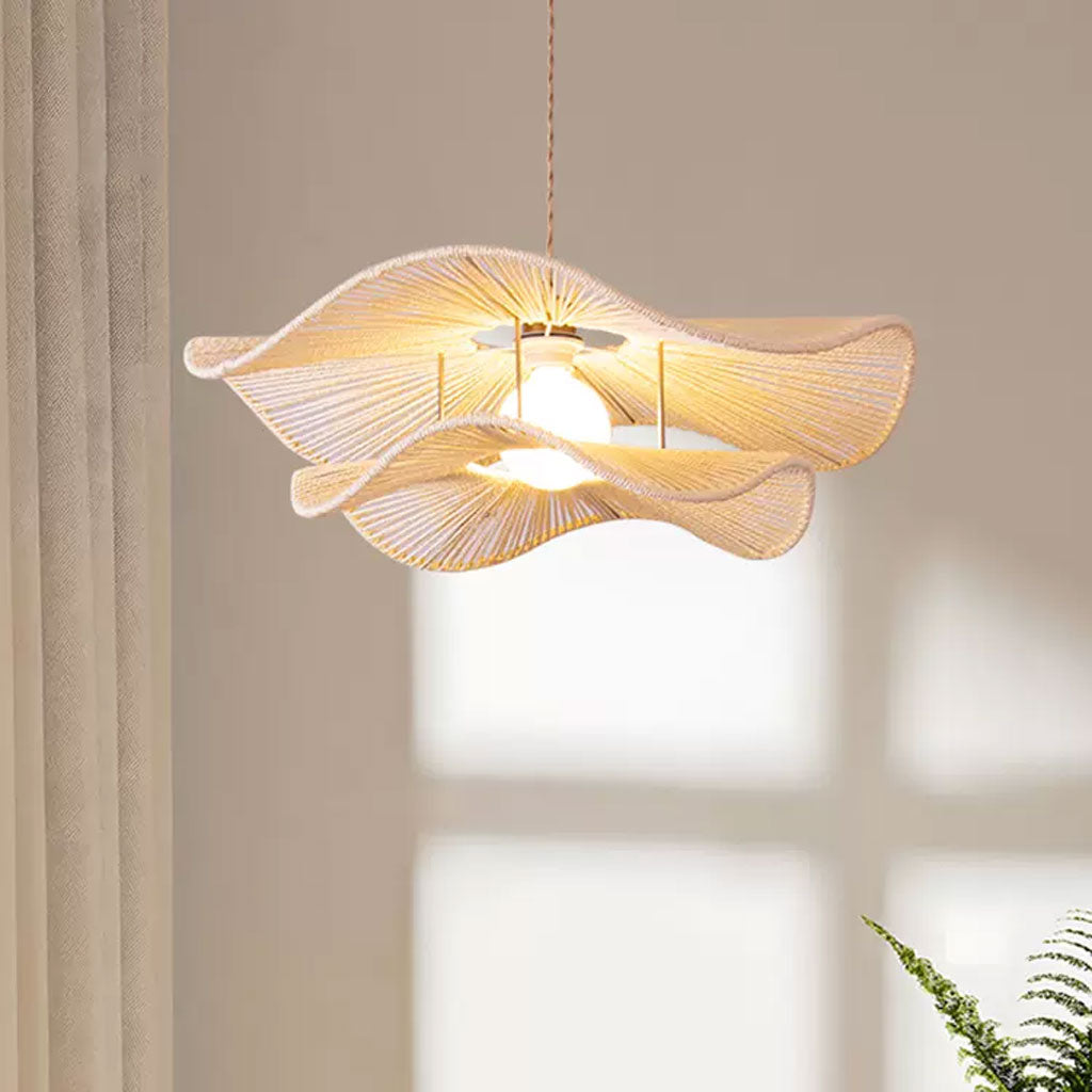 Minimalist white woven wave pendant shade casting elegant linear shadows against a plain cream-colored wall.