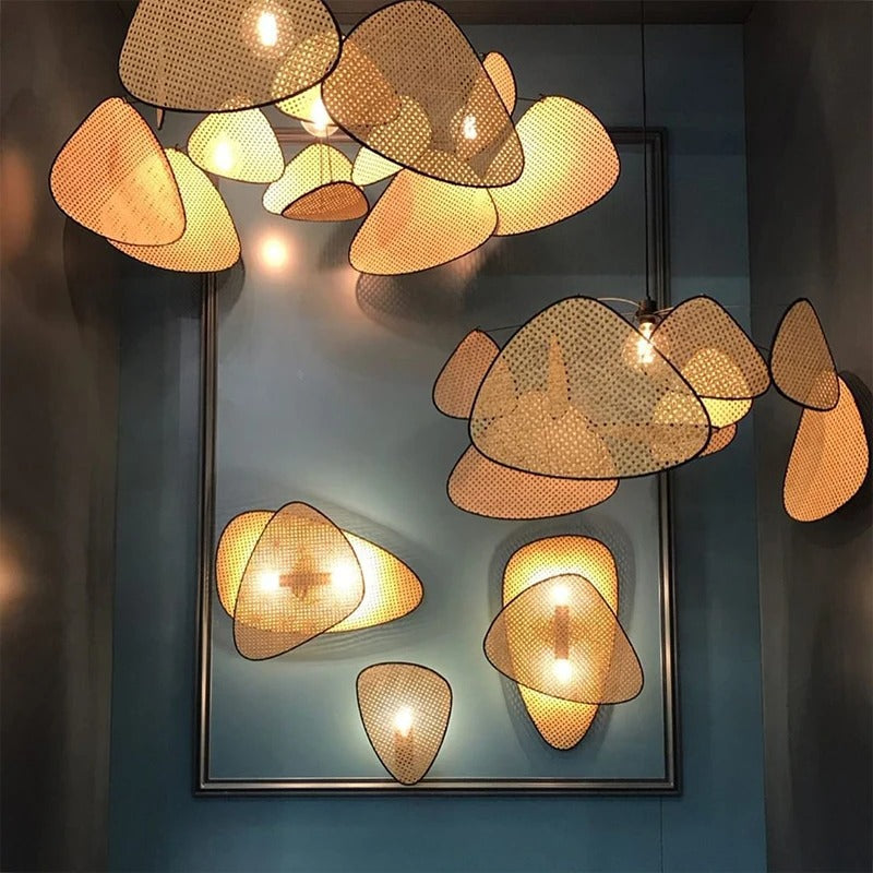 Modern boho cane webbing chandelier showcasing organic wicker textures and a central exposed warm bulb.