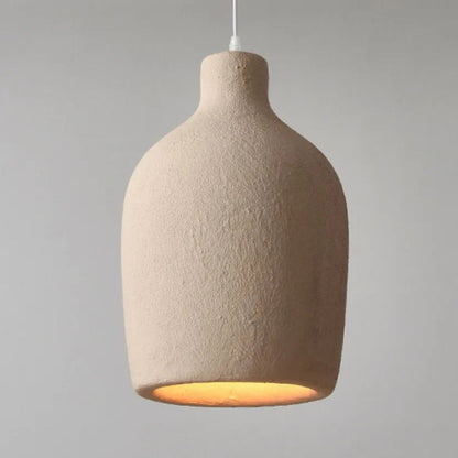 Modern primitive ceramic ceiling lamps in beige color hanging next to a decorative dry branch tree.