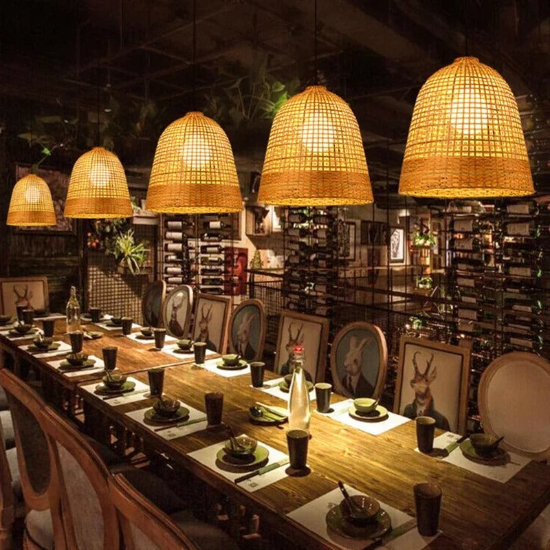 Modern rattan hanging light cluster with four unique geometric woven shades illuminating a contemporary dining space.