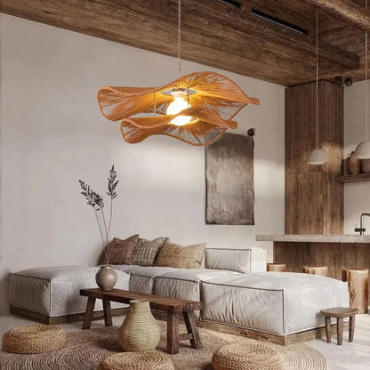 Modern wicker chandelier styled as a center statement piece in a luxury living room with a large round jute rug and rattan poufs.