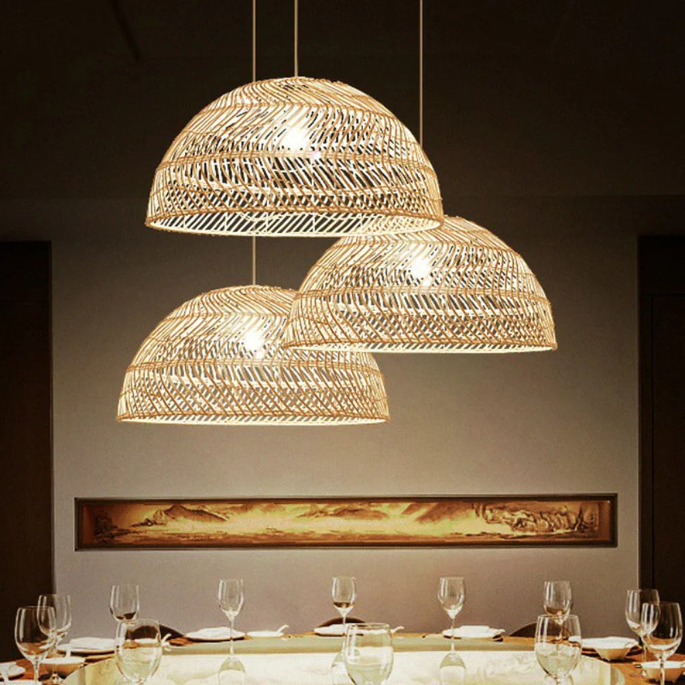 Multi-light bamboo pendant set creating a cozy atmosphere with detailed basketry over a contemporary dining space