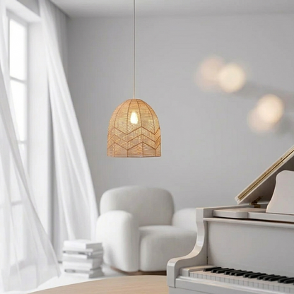 Nordic style woven rattan light fixture with a clean white hanging cord suspended against a soft plain background.