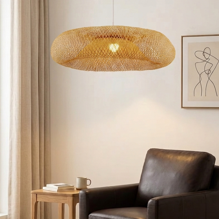 Open-weave rattan hanging shade with a round, flattened dome silhouette projecting a warm internal illumination.