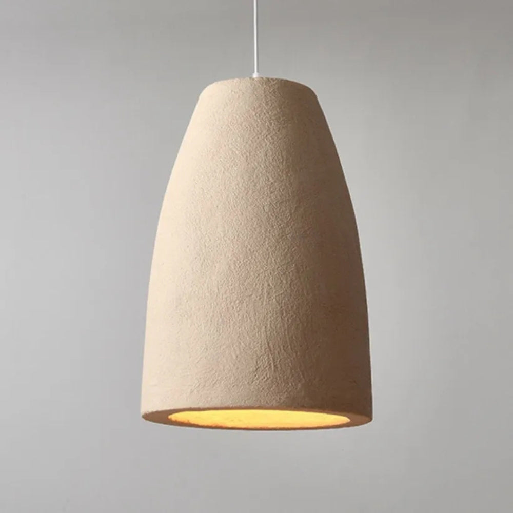 Set of three organic modern ceramic pendant lamps in a neutral-colored living space with a large circular mirror.