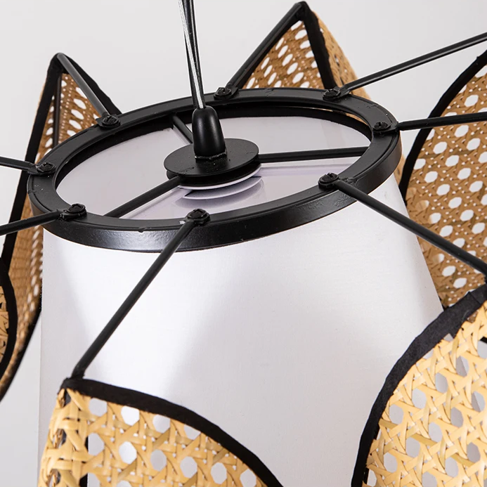 Pendant light in minimalist style, using rattan and fabric, providing clean lines and soft ambient lighting for modern rooms.