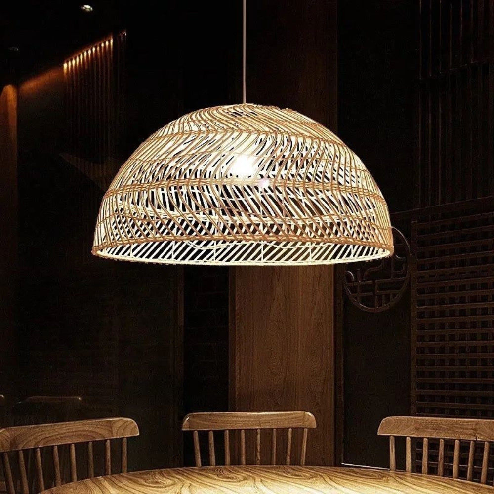 Rattan dome pendant light with an intricate chevron weave pattern hanging beautifully over a dining area.