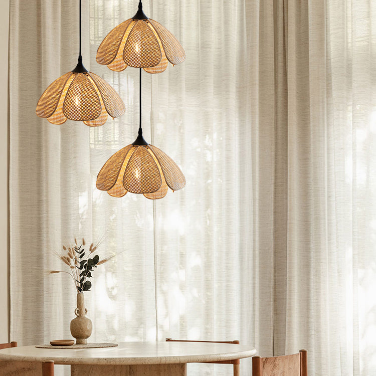 Rattan flower pendant light hanging over a dining table