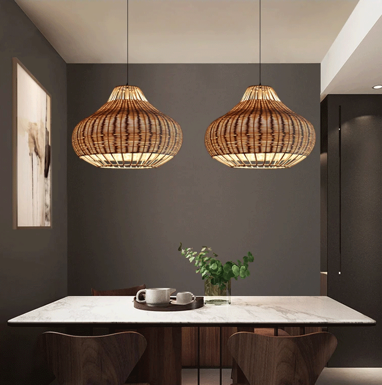  Modern wicker hanging light fixture casting a warm glow over a marble kitchen counter.