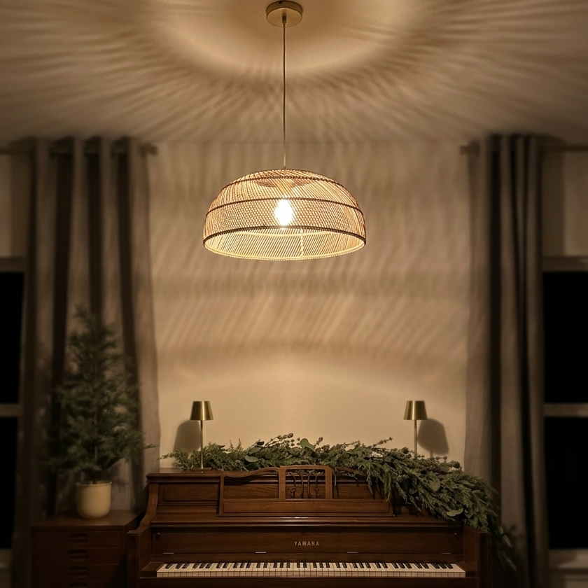 Elegant rattan hanging light fixture illuminating a classic piano room