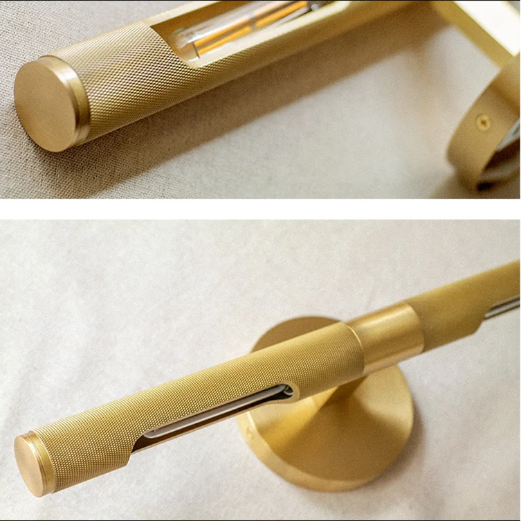 A close-up of a brass bathroom fixture, showing both a detailed view of the cylindrical handle with a textured grip and a view of the round mounting base on a light fabric background.