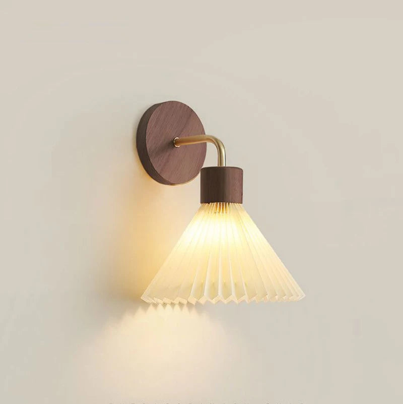 Wall-mounted lamp with pleated shade on a light gray background