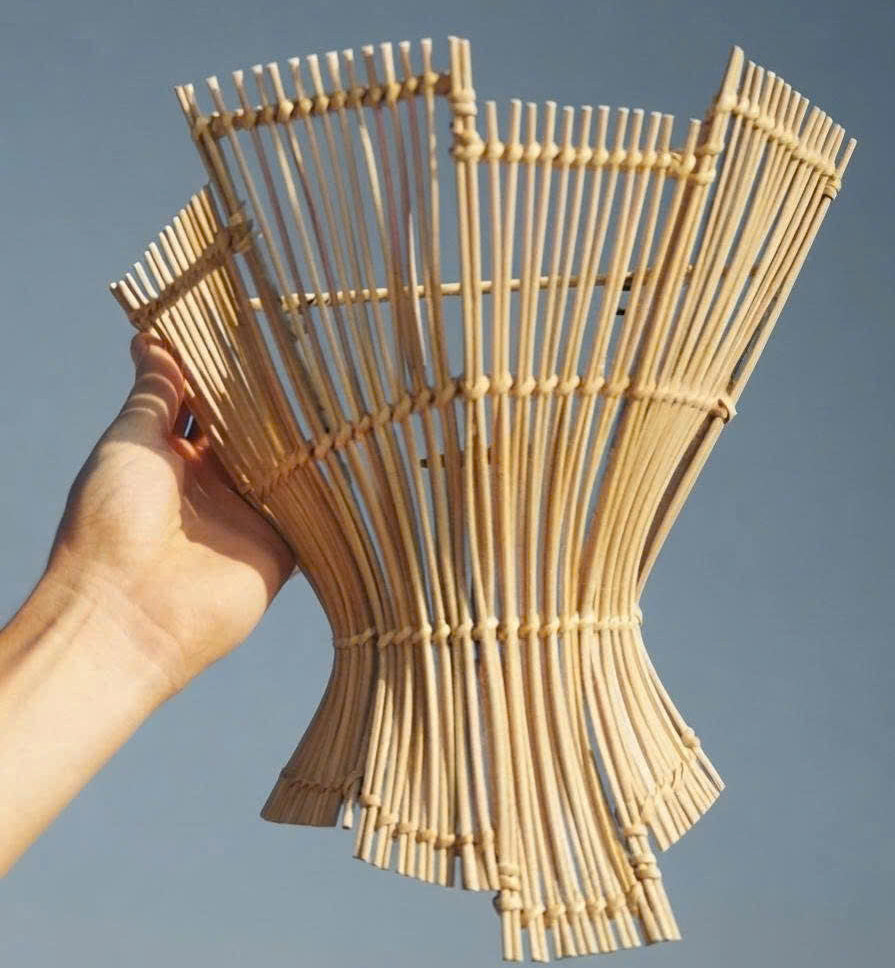 Sustainable handmade rattan wall sconce with organic texture for eco-friendly interior design.