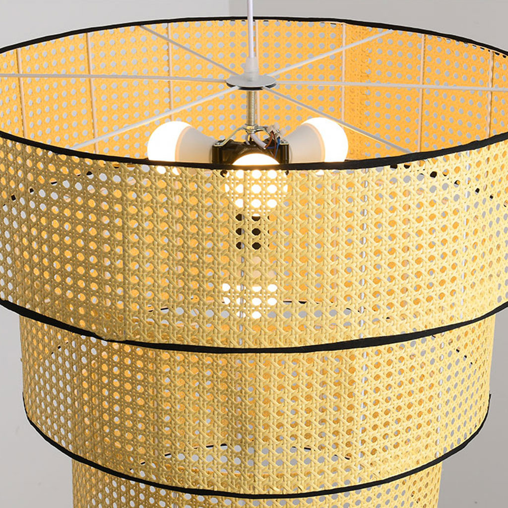 Elegant three-tier rattan pendant light for bedroom interior decor.