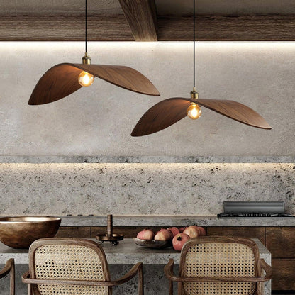 Unique curved wood pendant light illuminating a minimalist dining area