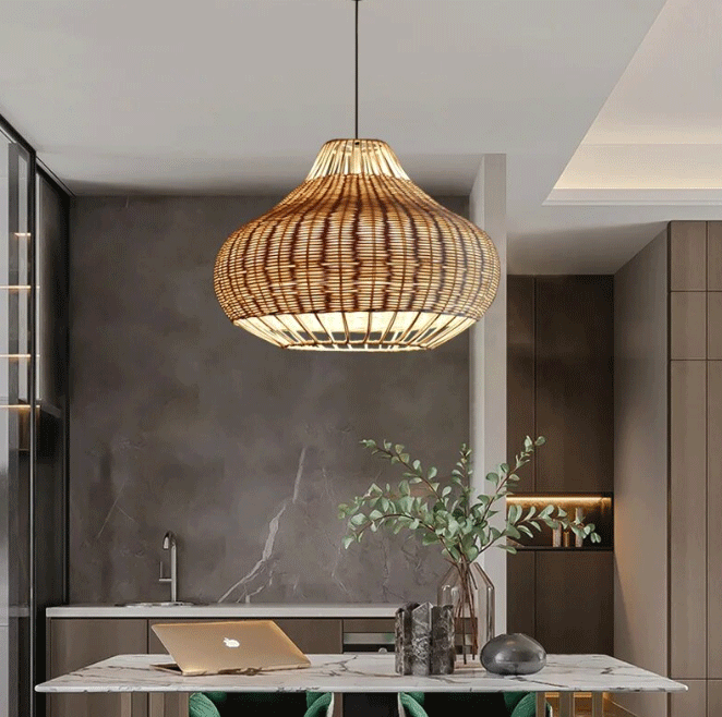  Bohemian woven rattan chandelier lit up in a neutral-toned kitchen interior with marble countertop.