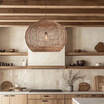 Modern organic woven rattan dome pendant light illuminating a kitchen island workspace