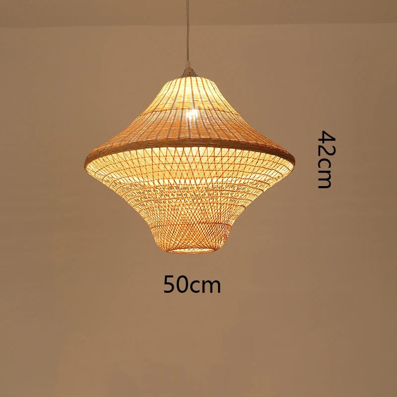 Zen inspired woven bamboo chandelier set of four mismatched natural shades glowing warmly against a soft plain background.